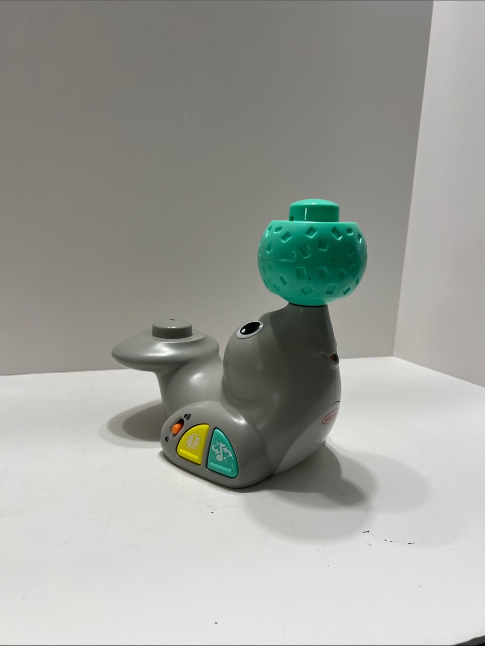 Infantino Gray Seal Toy with Green Ball and Yellow Buttons